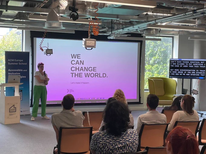 Photo of a speaker presenting to the audience at the inaugural Association for Computing Machinery Europe Summer School at the STEAMhouse building.