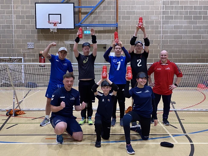 Cambridge Dons Aspire Day attendees holding their water bottles and hands in the air in celebration as if they've scored the winning goal in a game!