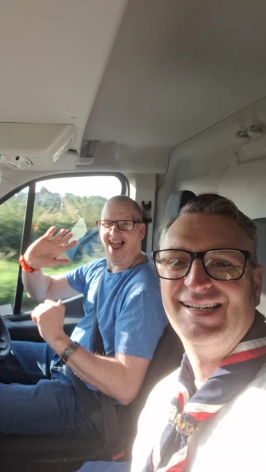 Two Scout Volunteers in the front of a van