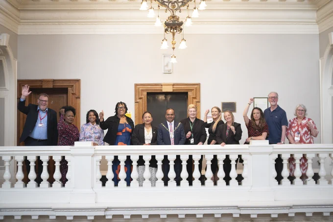 Learning provider representatives on the balcony in the town hall  cheering