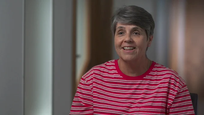 Image of Denise, Moorfields Private cataract patient in a red and white stripped t-shirt.