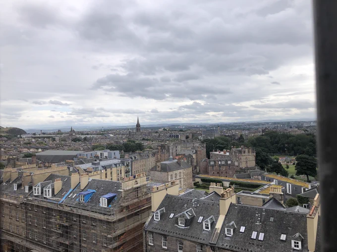 View west across rooftops towards distant mountains