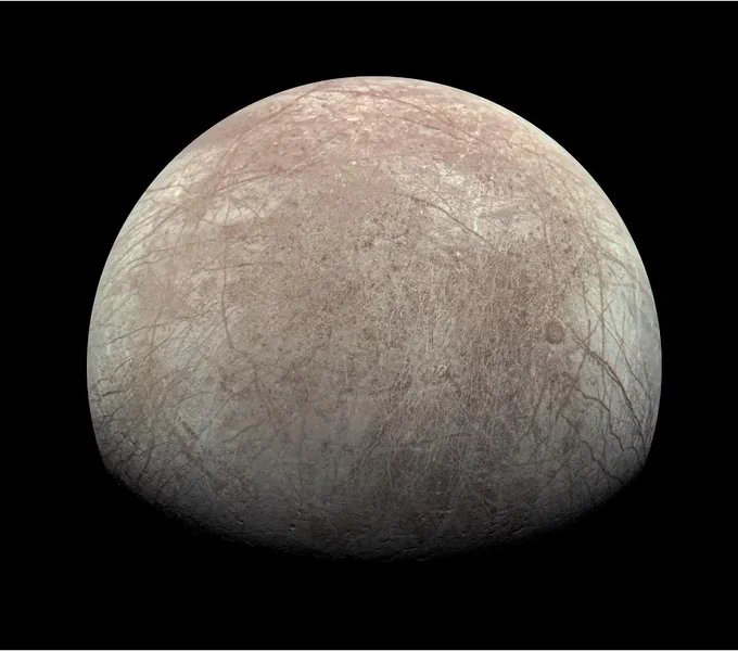 This view of Jupiter's icy moon Europa was captured by JunoCam, the public engagement camera aboard NASA's Juno spacecraft, during the mission's close flyby on Sept. 29, 2022. The picture is a composite of JunoCam's second, third, and fourth images taken during the flyby, as seen from the perspective of the fourth image. North is to the left. The images have a resolution of just over 0.5 to 2.5 miles per pixel (1 to 4 kilometers per pixel). As with our Moon and Earth, one side of Europa always faces Jupiter, and that is the side of Europa visible here. Europa's surface is crisscrossed by fractures, ridges, and bands, which have erased terrain older than about 90 million years. Citizen scientist Kevin M. Gill processed the images to enhance the color and contrast.
NASA/JPL-Caltech/SwRI/MSSS Image processing: Kevin M. Gill CC BY 3.0