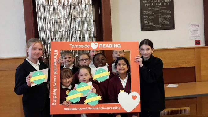 A photo of pupils from Livingstone Primary School in Mossley at the Reading Champions Celebration event at Dukinfield Town Hall.