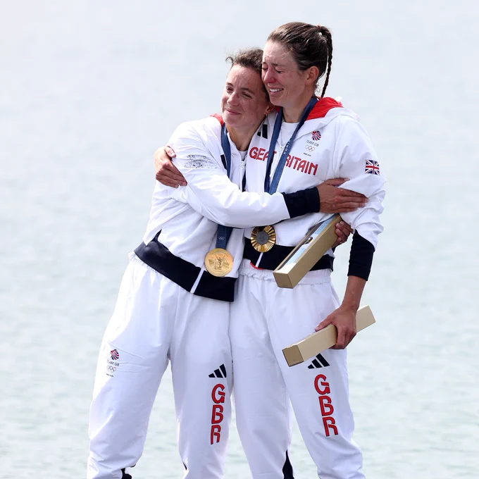 Imogen Grant and Emily Craig hugging on the podium after winning gold in the lightweight women's double sculls.