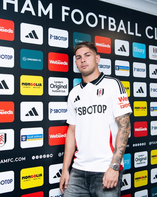 Emile Smith Rowe pictured in front of the sponsor board at Craven Cottage.