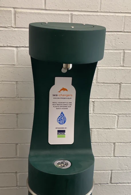 Front shot close up of the inlet of the water station where you put your bottle to fill it with water. It has the names of the sponsors and funders depicted on a plaque on the inner back facing the public to read. (c) Clare Galpin