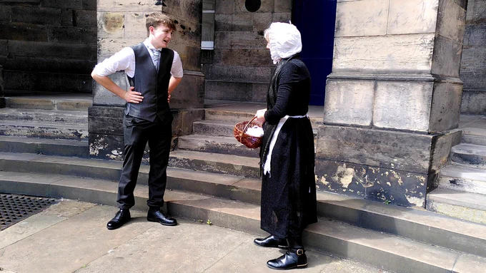 Young Charles Darwin in discussion with his landlady Mrs Mckay at Edinburgh University Old College