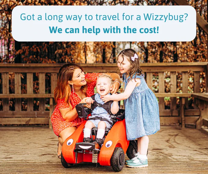 A family laughing together outside, mum is crouched down beside her son who is using a Wizzybug powered wheelchair with words 'Got a long way to travel for a Wizzybug? We can help with the cost!'