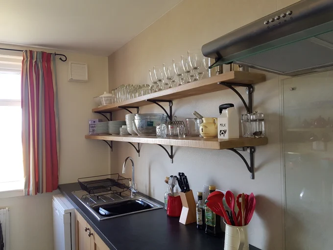 Kitchen shelves with glasses and glass bowls