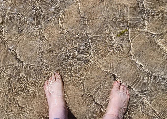 Feet paddling in the sea