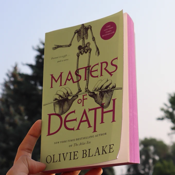 Masters of Death by Olivie Blake is being held in a hand