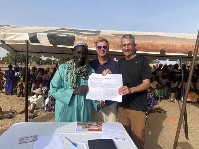 (PHOTO: Chief Khokhan Nolong of Nguiddine Keur Sara, Senegal with Team Dayā members Jeff Green and Jay Sears during the welcome ceremony on June 24, 2024.)