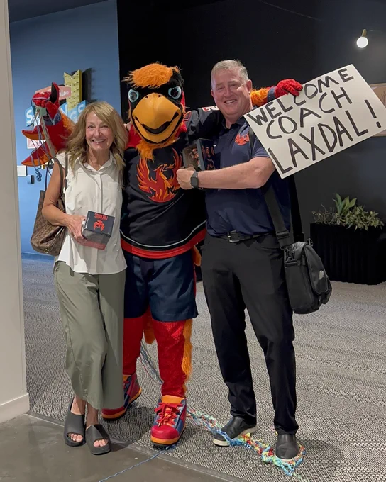 Fuego taking a photo with new Firebirds Head Coach Derek Laxdal and his wife Hali.