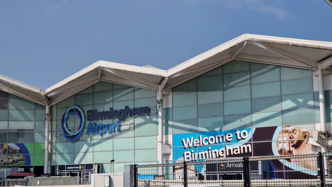 Building with the words Birmingham Airport on.
A sign below reads Welcome to Birmingham