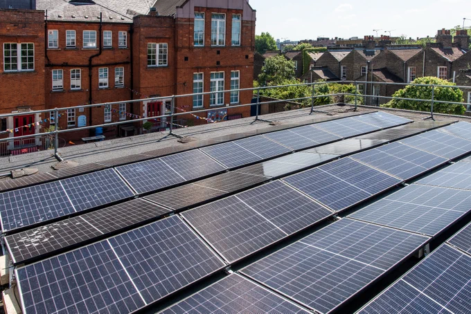Solar panels at St John and St James School with the school building in the background.