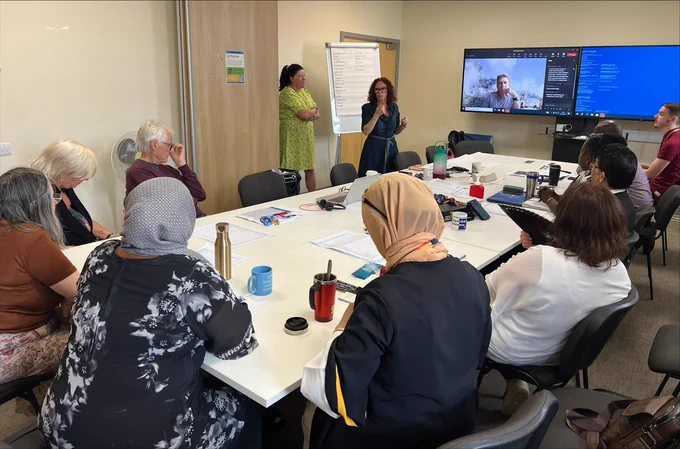 Colleagues in a meeting room working on our Trust Strategy.
