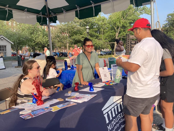 people stand at booth for Middlesex Community College