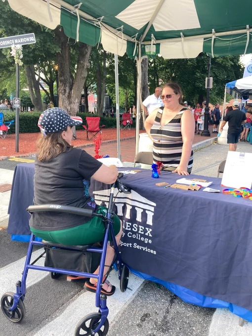 people stand at booth for Middlesex Community College