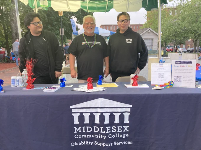 people stand at booth for Middlesex Community College