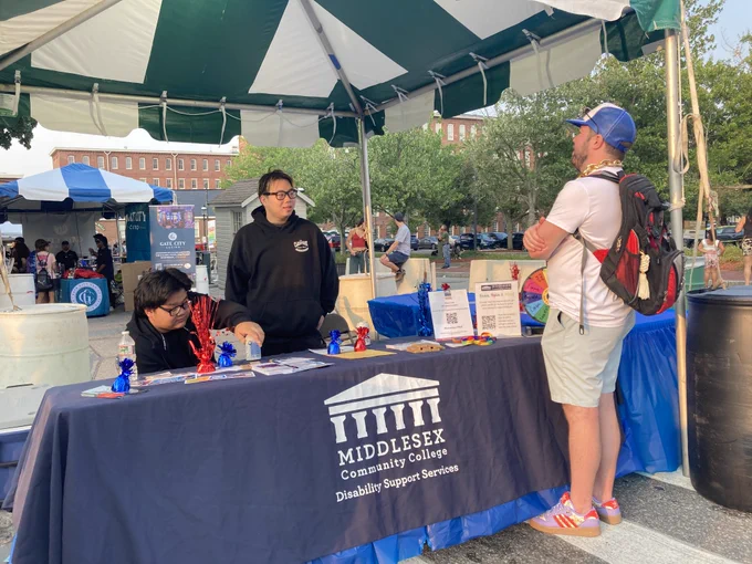 people stand at booth for Middlesex Community College