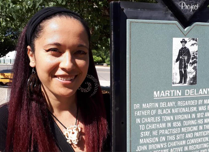 Deirdre McCorkindale smiles outside standing next to a plaque.