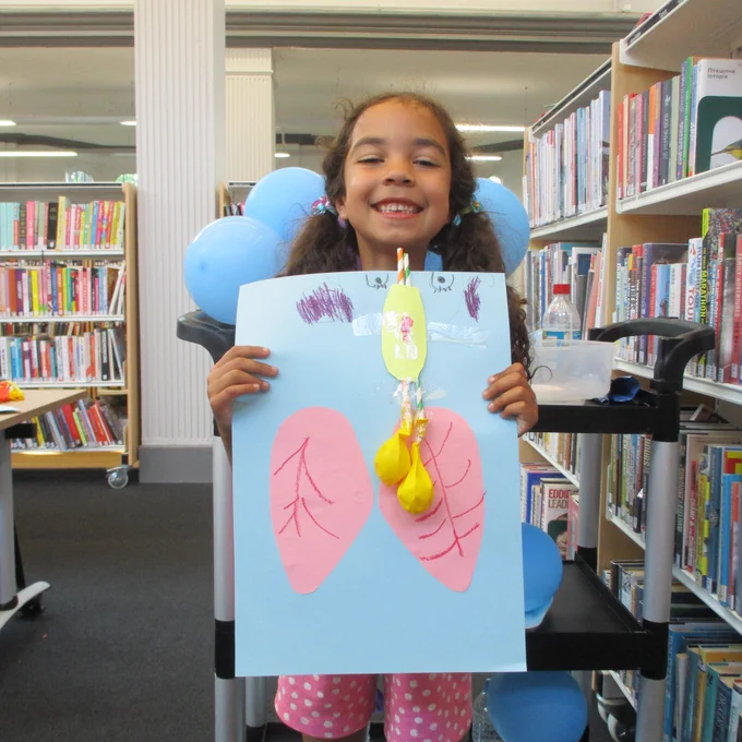 Girl smiling with balloon rocket
