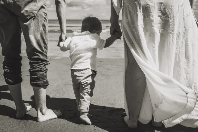Jordan, Ruth and Teddy Barrett face out to sea in this black and white image.