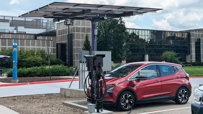 An electric car charges its battery at the new solar-powered charging station in the A28 parking lot.