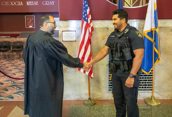 Officer Aguero shakes Judge Thadani’s hand.