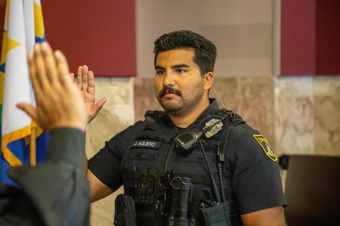 Officer Aguero raises his right hand to be sworn in.