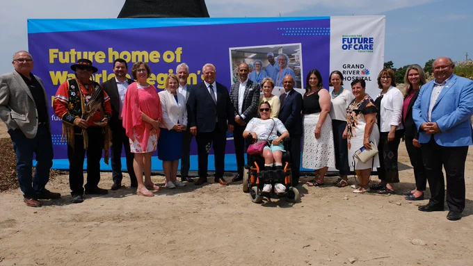 Delegates posing together at the new site of the Grand River/St. Mary's General hospital joint hospital on north campus of the University of Waterloo