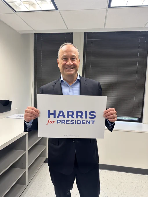 Second Gentleman Douglas Emhoff holding up a "Harris for President" sign