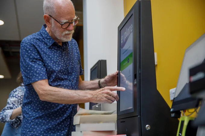 A photograph of a man returning books at our self-service machine.