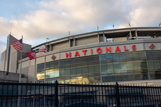 Stadium with "NATIONALS" in red on side above glass paneling.