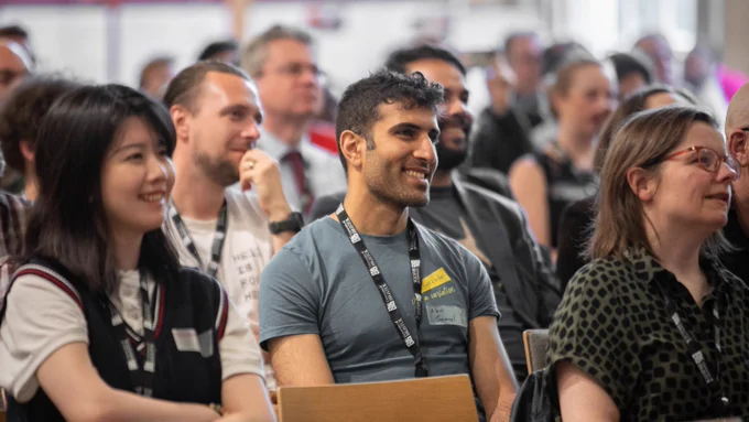 Smiling audience, enjoying a talk at an event