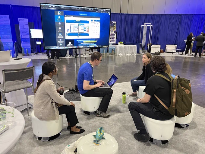 A group of people sitting on small stools to learn from CidiLabs. 