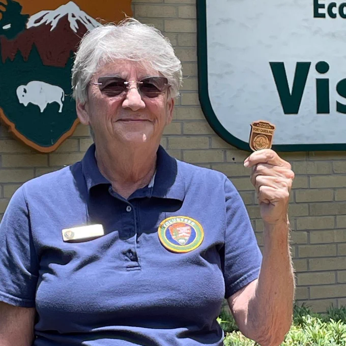 volunteer holds senior ranger badge 