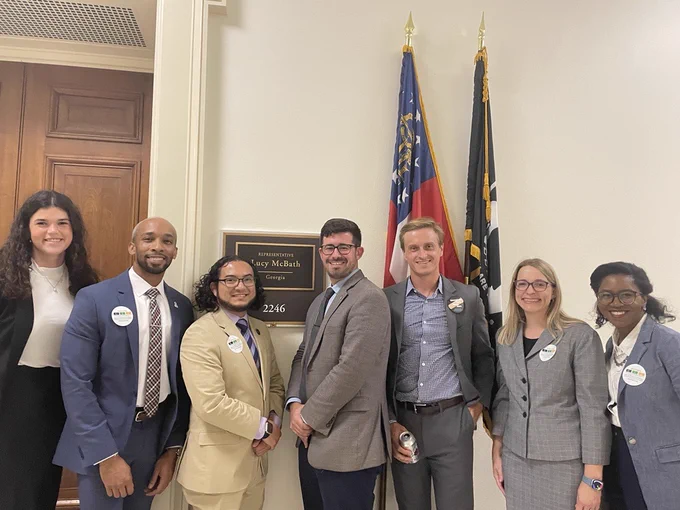 NAfME advocacy staff Amanda Karhuse with CEF staff outside Rep. McBath's office with staff. 