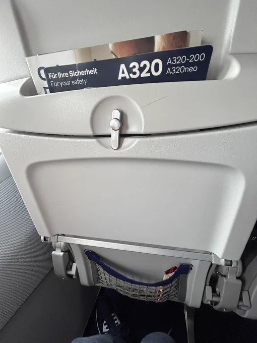 The view in front of Laurie on an Airbus A320 aircraft showing the legroom.