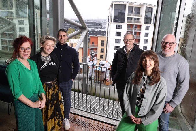 Nick Gardner with project partners from Baltic, NEYDL and Newcastle University posing together on Baltic rooftop in front of beehives.