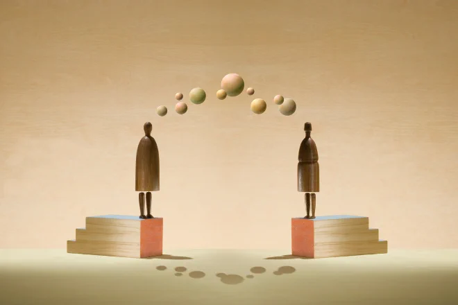 The people standing on elevated surfaces facing each other. There are floating spheres between them, representing stories or thoughts. The image is graphic designed.