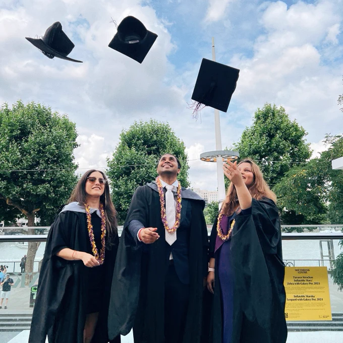 The graduates throw their caps