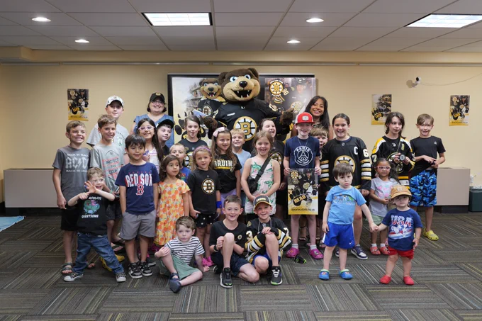 Blades posing with children at the West Boylston library
