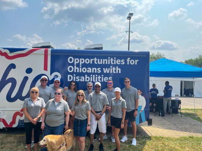 OOD's Executive team stands in front of the mobile unit at the Ohio State Fair. 