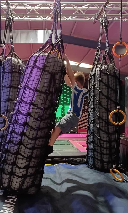 One young person climbing along one of the obstacles. 