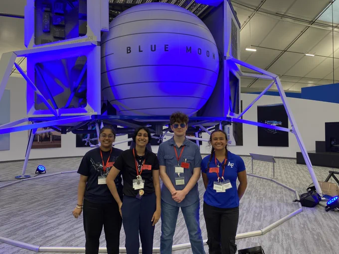 four people in front Blue Moon