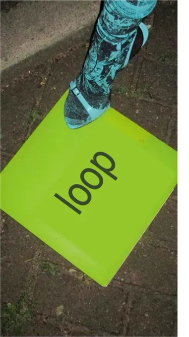 a picture of the brat album with the name replaced as "Loop". The album is sitting on pavement with Charlie XCX stepping on it