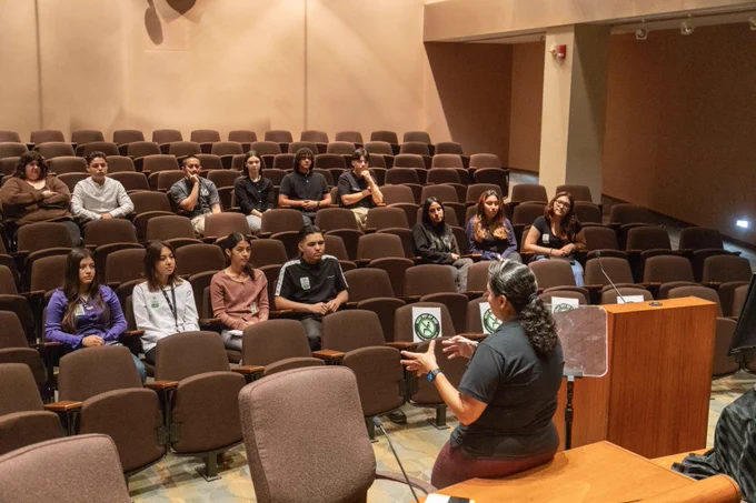 A group of EXP Summer interns watching a presentation in the Los Angeles Harbor Commission Board Room