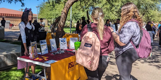 Student worker sharing upcoming events with peers on Tabling Tuesday